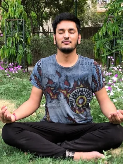 A practitioner meditating outdoors, surrounded by nature. The techniques I teach can be practiced anywhere to help you find a center of calm amidst daily life.