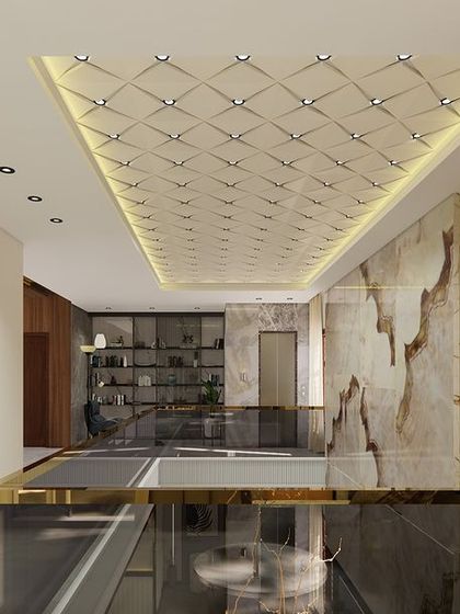 A view from the upper level of a double-height living room, showcasing the intricate CNC-engraved ceiling design. This detail adds a layer of texture and sophistication to the space.