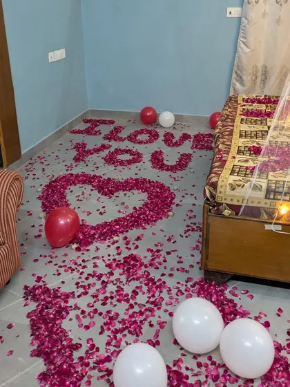 The 'I LOVE YOU' message made of rose petals as seen from the side of the room, creating an immersive romantic experience.
