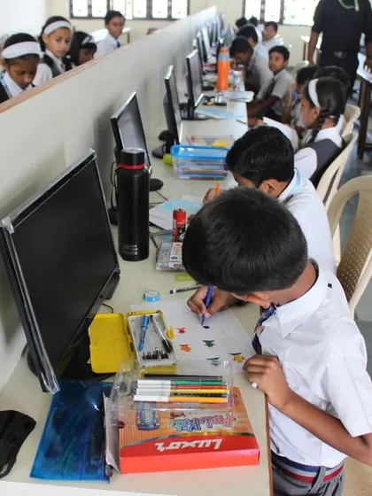 Young participants collaborating and competing in the computer lab during the 2023 Olympiad.