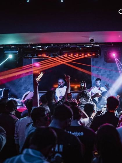 The energy of a packed club night, with lights cutting through the crowd. My goal is to create a completely immersive audio-visual experience on the dance floor.