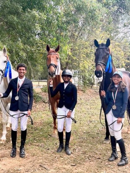 My riders celebrating their success in the NEC Dressage Freestyle event. Their podium finishes, including a silver medal on a borrowed horse with only four days of practice, show their adaptability and skill.