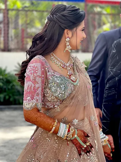 A beautiful reception look with a multi-colored pastel lehenga and soft, glowing makeup.
