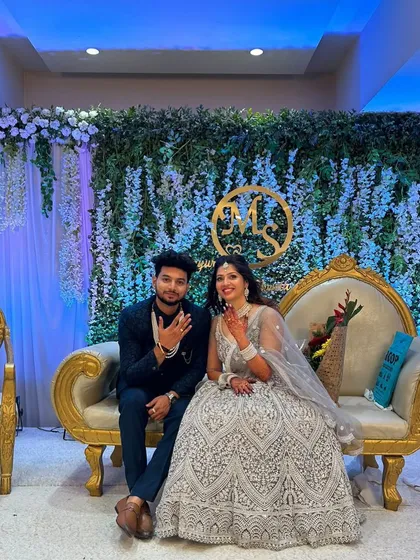 Posing on their engagement stage. The bride's radiant makeup and the groom's polished look were designed to look great both in person and in photos.