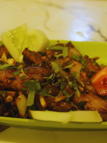 A close-up of one of our dry fry preparations. You can see the fresh herbs, garlic, and spices that we use to make every dish flavourful.