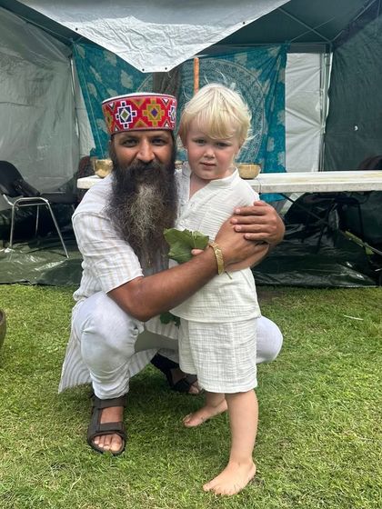 A sweet moment with a young boy at an outdoor festival. Yoga is for everyone, and it is a joy to see its light touch even the youngest souls.
