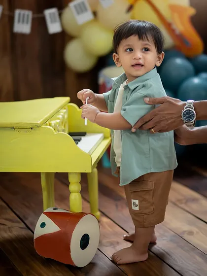 A helping hand to reach the piano keys. We always ensure our little clients are safe and supported while they explore our fun setups.