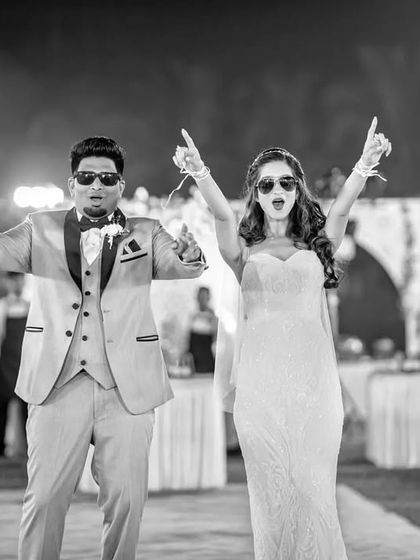 Another angle of the fun-loving couple's entrance. This black and white photo captures their synchronized pointing, a moment of pure fun.