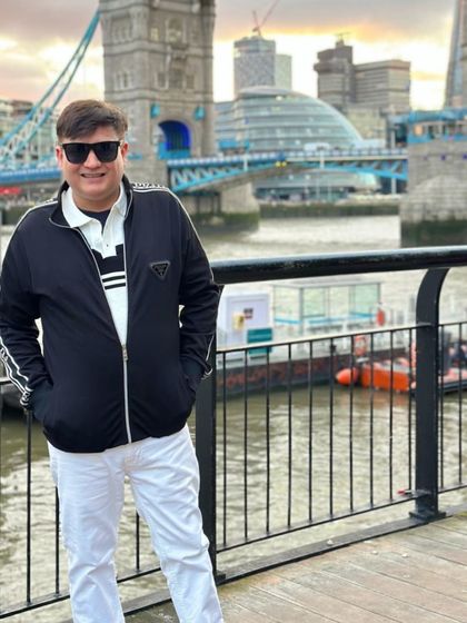 Posing with the iconic Tower Bridge in the background. A classic tourist shot with a fashionable twist.