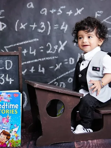A wider shot of the "back to school" themed first birthday, showing the adorable little boy at his desk.