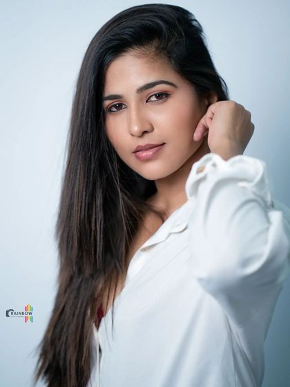 Another take on the classic white shirt look, showing a different angle and expression.