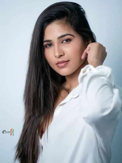 Another take on the classic white shirt look, showing a different angle and expression.