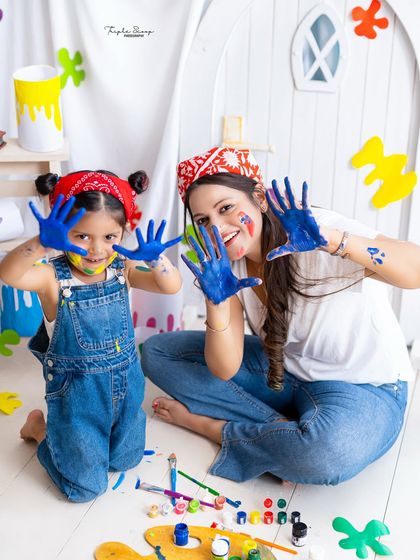 A messy and fun paint-themed photoshoot with mom and daughter. These "smash and splash" sessions are a great way to capture pure, uninhibited joy.