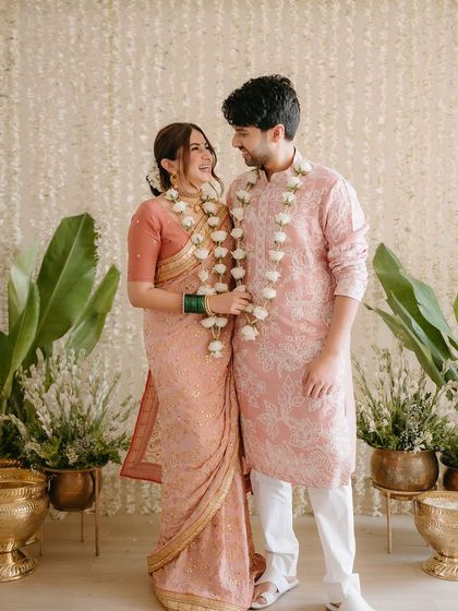 A beautiful portrait of Aashna and Armaan from their intimate signing ceremony, set against a simple yet elegant backdrop of hanging tuberose strings.