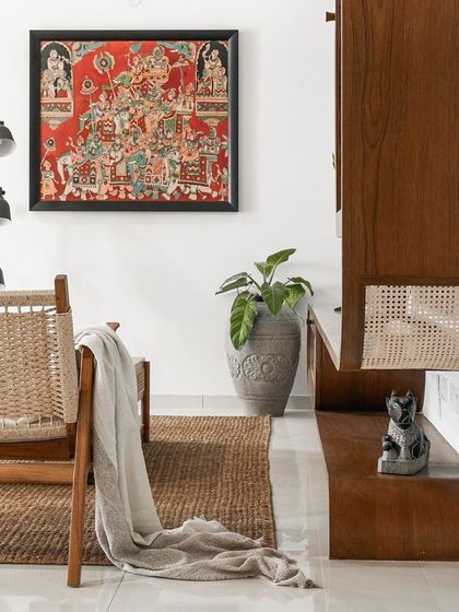 A custom television unit in a client's penthouse. Its curved sides are adorned with rattan shutters, complemented by a custom storage unit that adds depth and visual interest.