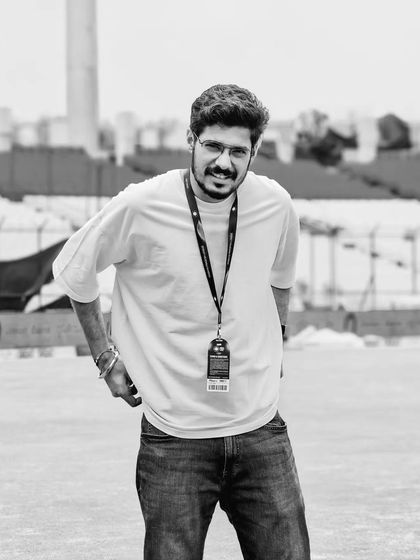 A black and white portrait of me on the field during the MPL 2024 in Gwalior. I am comfortable and experienced in working within large stadium environments.