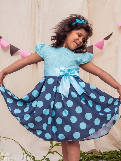 Twirling in the blue polka dot dress. The full skirt has great movement, making it as fun to wear as it is to look at.