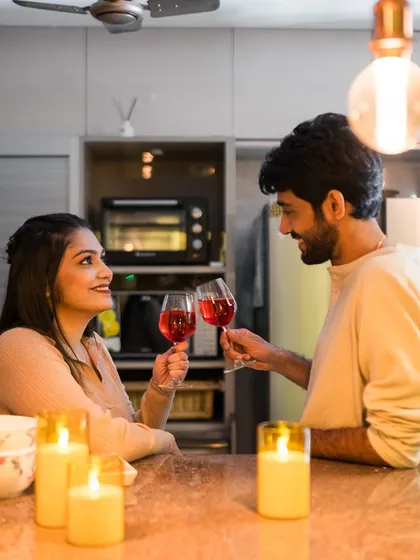 A toast to their future, surrounded by the warm glow of candles in their own kitchen. At-home shoots are incredibly personal and meaningful.