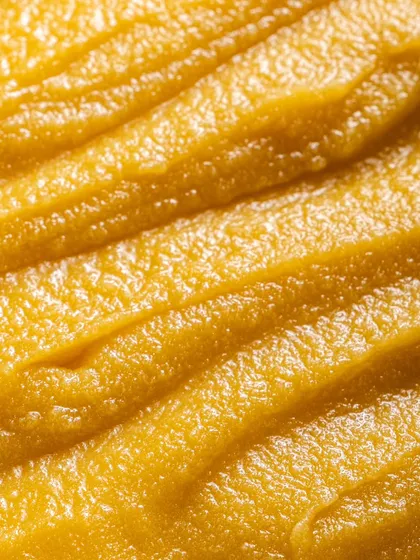 A macro shot that emphasizes the pure, grainy quality of the ghee. Capturing these details is crucial for D2C food brands that pride themselves on quality ingredients.