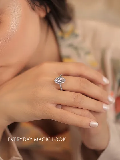 This marquise-cut diamond ring is designed for what I call the "everyday magic" look. The elongated shape of the diamond, set in a delicate halo on a pavé band, creates a feeling of grace and brilliance that elevates any moment.