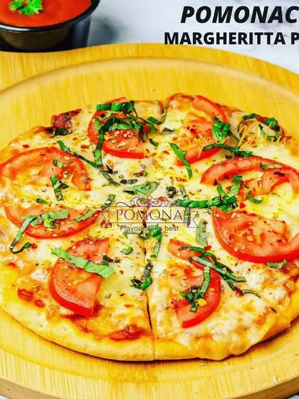 A classic Margherita pizza, handcrafted with a tangy tomato sauce, fresh mozzarella cheese, and basil leaves on a perfectly baked crust. A simple yet delicious option that's always a hit.