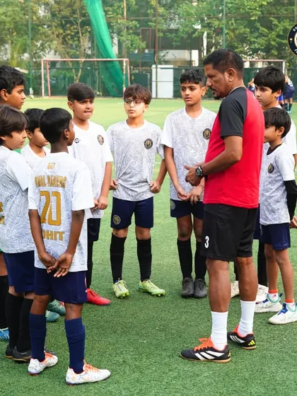 The team listens intently as their coach provides tactical advice during a timeout. We teach our players to be students of the game, always ready to learn and adapt.