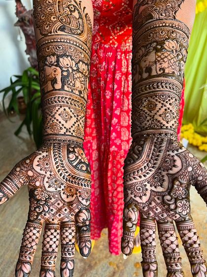 A top-down view of the peacock and elephant bridal design, showing the symmetry and balance of the artwork.