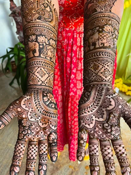 A top-down view of the peacock and elephant bridal design, showing the symmetry and balance of the artwork.