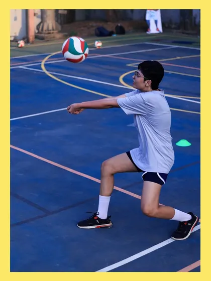 A young player gets low to the ground for a controlled pass. We teach our athletes to be agile and ready for any ball that comes their way.