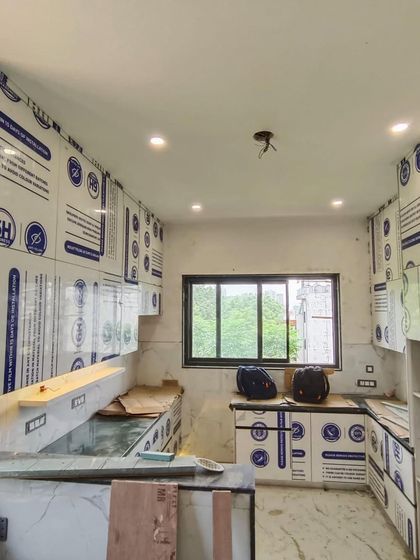 A wide view of the U-shaped kitchen during installation. Our team works carefully to assemble the factory-finished modules on-site, ensuring a perfect fit and finish.