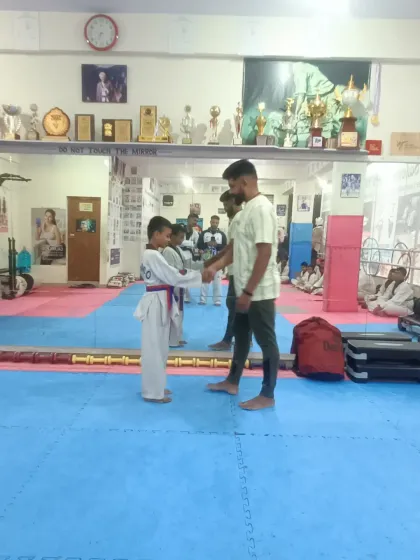 A student receives his red belt.