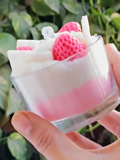 A slightly different angle of the strawberry ice cream candle, held to show its details.