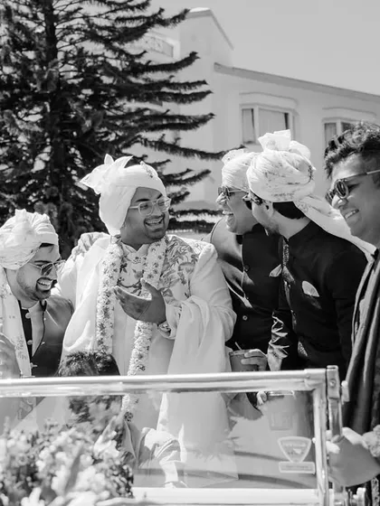 A candid moment of laughter and fun between the groom and his groomsmen, showcasing the bond of friendship on the wedding day.