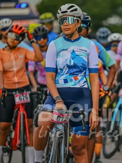 A female rider, poised and ready at the start line. I am committed to creating an equal and empowering environment for all women in cycling.