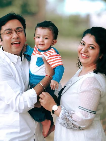 A happy family moment captured outdoors. The genuine smiles and interactions are what make these lifestyle family portraits so special.