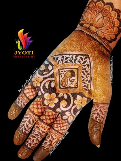 This Indian mehndi design features a small peacock inside a square frame, surrounded by flowers. The contrast between the dark and light areas makes the pattern very eye-catching.