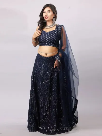 The studio version of our 'Sapphire from Heeramandi' shoot. The clean white background makes the deep blue lehenga the absolute star of the photo.