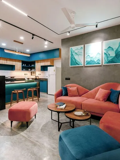 This project shows how I love to play with color to reflect a client's personality. By combining a custom blush sofa with bold teal kitchen cabinetry and polished concrete floors, we created an apartment that is modern, vibrant, and full of character.