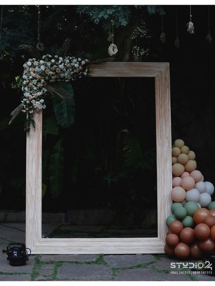 A versatile rustic photo frame, perfect for any outdoor or chic-themed event. Here it's styled with a modern balloon garland in earthy tones.