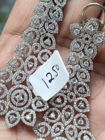 A pair of beautiful silver-plated American Diamond earrings with an intricate design. These are lightweight and perfect for adding some sparkle to your look without being too heavy.