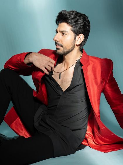 This relaxed, seated pose offers a more casual and intimate feel while still showcasing the stylish outfit.