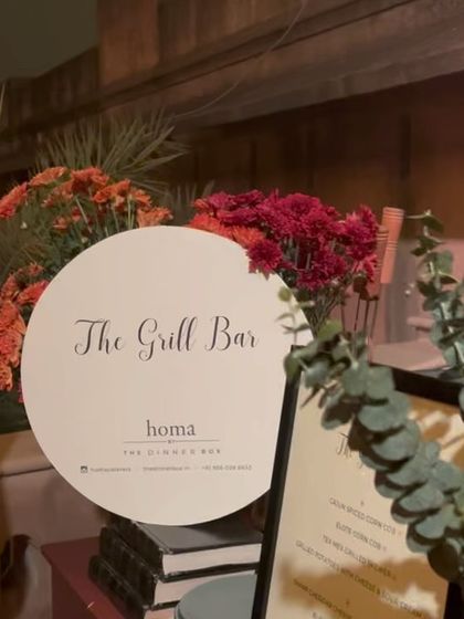 Our custom-designed signage for "The Grill Bar" at a destination event. This detail shows our end-to-end planning, ensuring every aspect of the culinary experience is branded and beautifully presented.