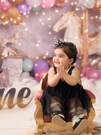 Another take on our carousel first birthday theme. The soft lighting and dreamy background create a magical setting for this milestone portrait.