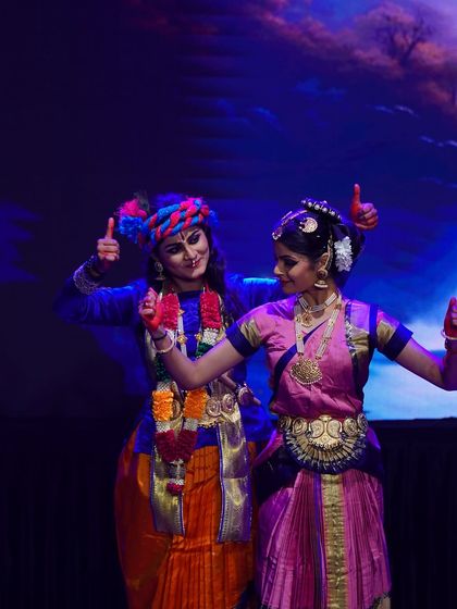 A fun, behind-the-scenes style shot of our Krishna and Gopika performers, sharing a thumbs-up after a successful scene.
