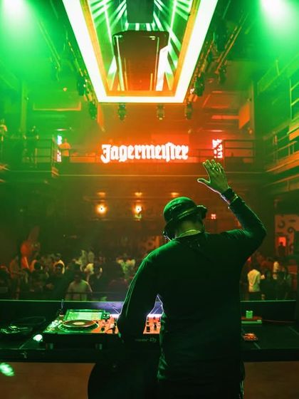 Another angle from the same set. Waving to the crowd while keeping the music flowing is part of the performance.