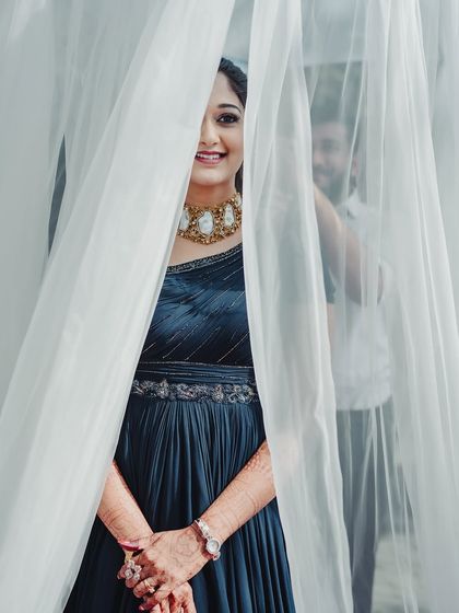 A playful and creative shot. This photo captures her happy smile and the beautiful details of her makeup and jewellery.
