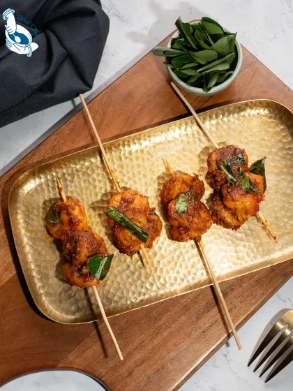 We present our Ghee Roast Prawns on satay sticks. Each prawn is slow cooked in a handcrafted ghee roast masala, offering a modern, elegant way to enjoy this traditional coastal flavor at your cocktail party or sundowner.