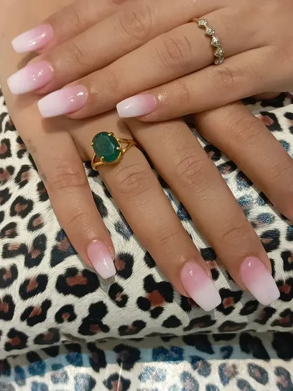 This is a perfect example of our classic pink-to-white ombre nail extensions. We achieve a seamless gradient on a squared coffin shape, creating a sophisticated and clean look that is perfect for any occasion, from daily wear to special events.