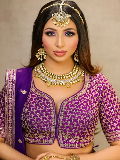 A full portrait of the model, looking regal and stunning in her purple ensemble.