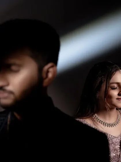 An artistic couple portrait inspired by cinematic lighting. The play of light and shadow creates a moody and romantic atmosphere.